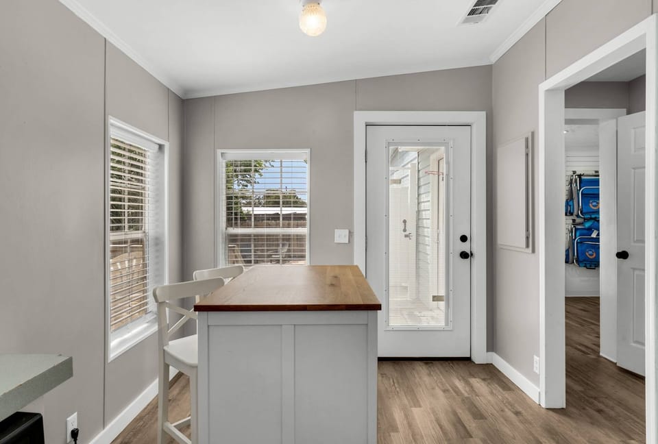 Breakfast nook with hightop seating and backdoor leading onto the outdoor deck.