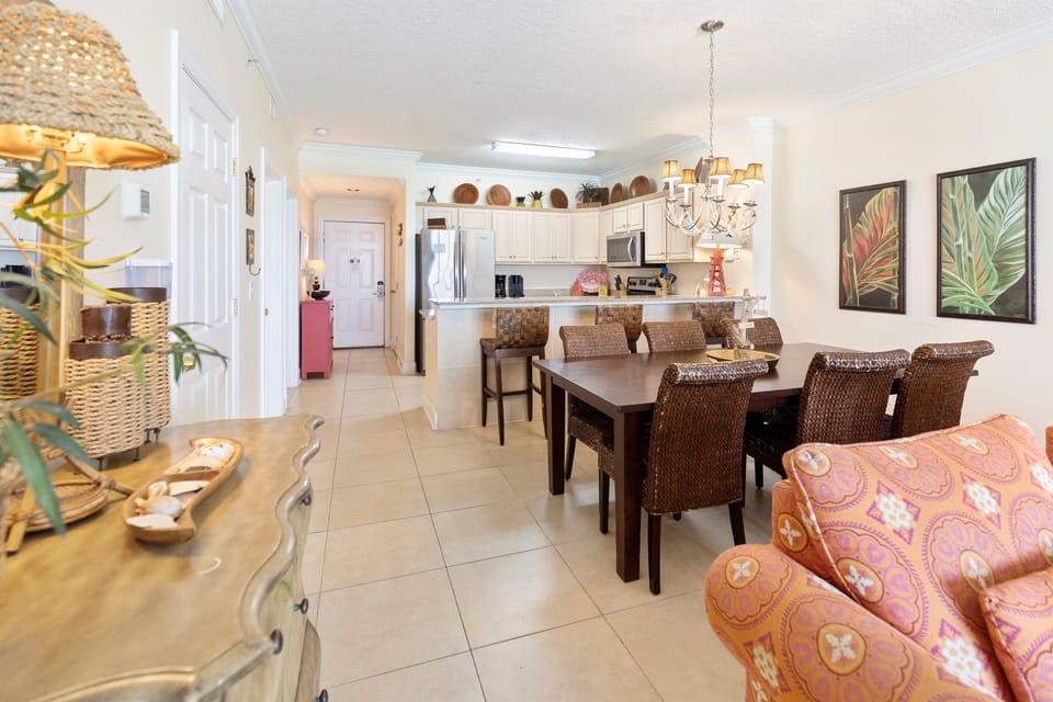 Your open-concept living space blends tropical elegance with modern comfort, featuring a spacious dining area and stylish seating perfect for memorable meals.