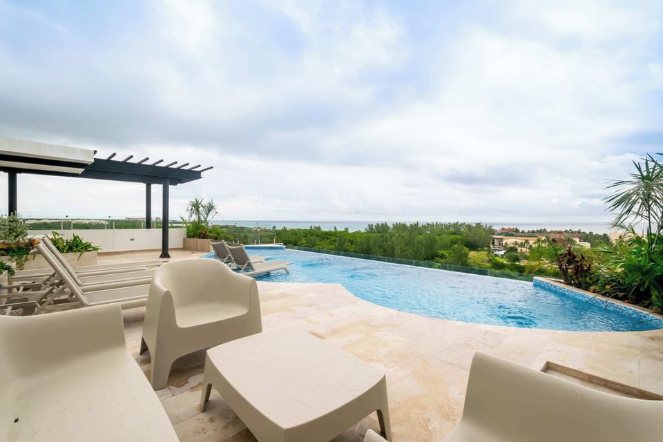 Unwind by the shared infinity pool with stunning ocean views.