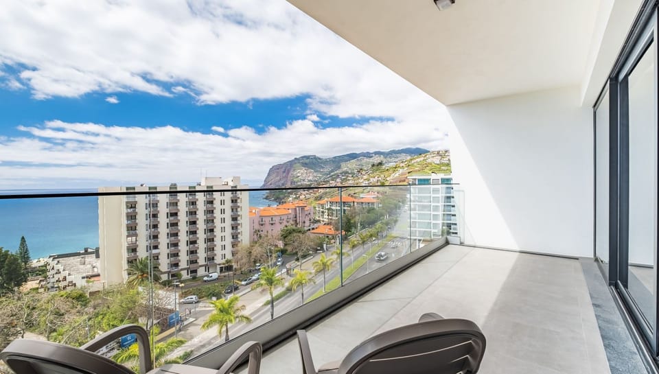 Step out onto the balcony of SkyView Penthouse by LovelyStay, where you can enjoy breathtaking views of the city, ocean, and mountains, creating the perfect spot to unwind and relax. #balcony