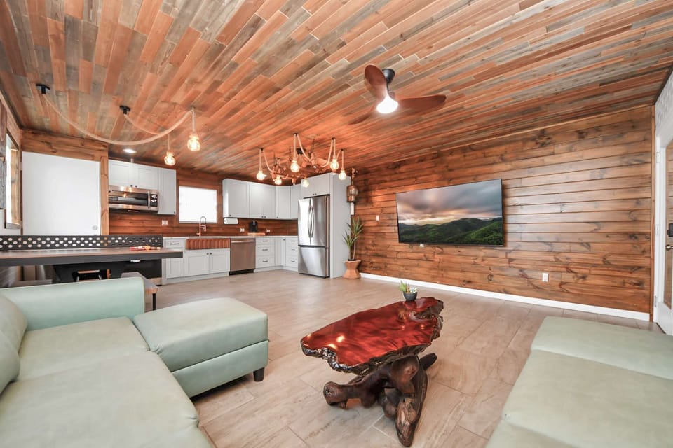 Cozy living area w/ wood-paneled ceilings, comfy seating &amp; a mounted TV for laid-back evenings