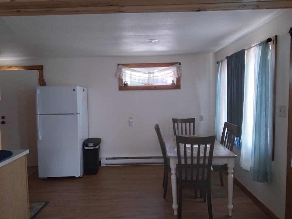 Dining Area:  Table with Four Chairs placed by the front window.