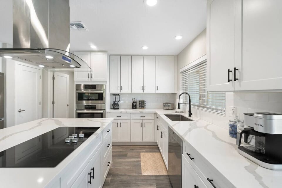 A bright, fully stocked kitchen with premium appliances and plenty of room for meal prep.