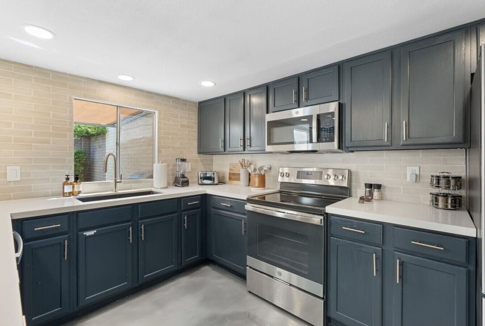 Fully equipped kitchen with stainless steel appliances and everything needed to prepare meals at home.