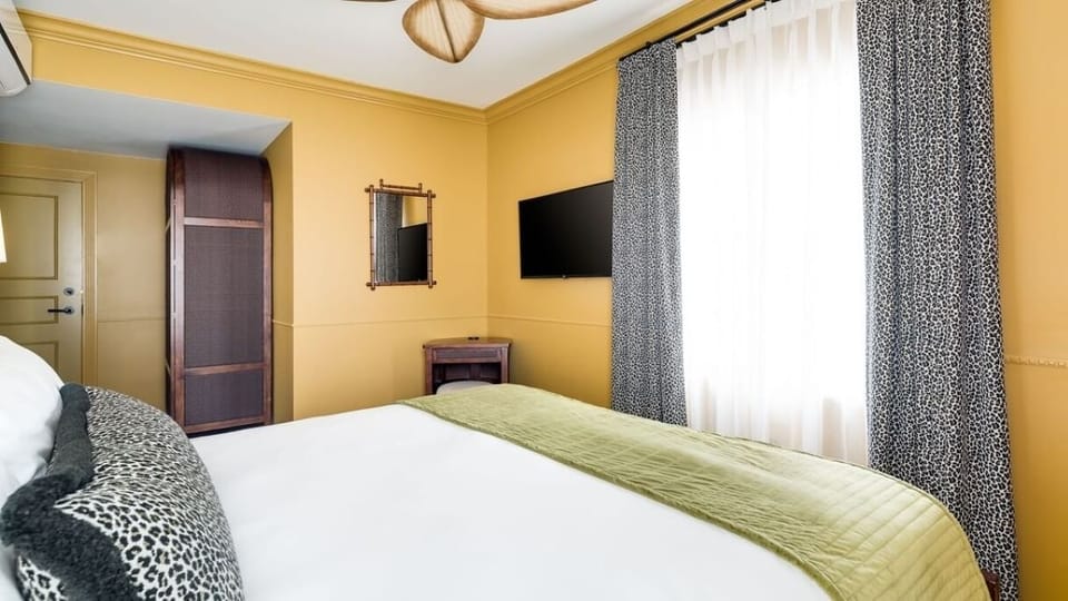Recharge in warm, inviting tones with soft, layered bedding.