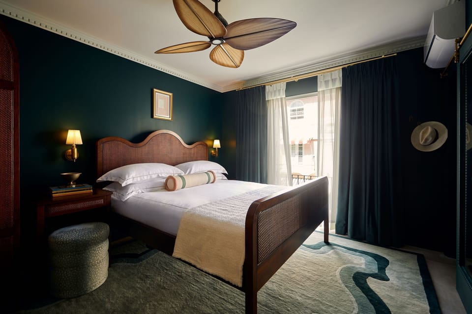 Unwind in a moody, design-forward room with balcony light.