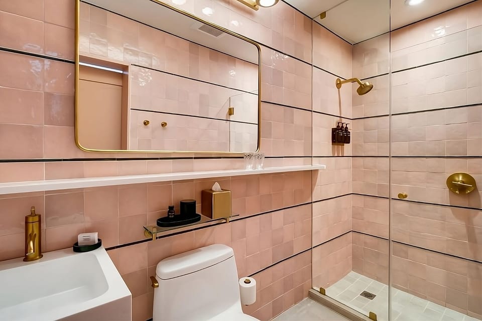 Enjoy a spotless, spa-like shower with elegant blush tilework.
