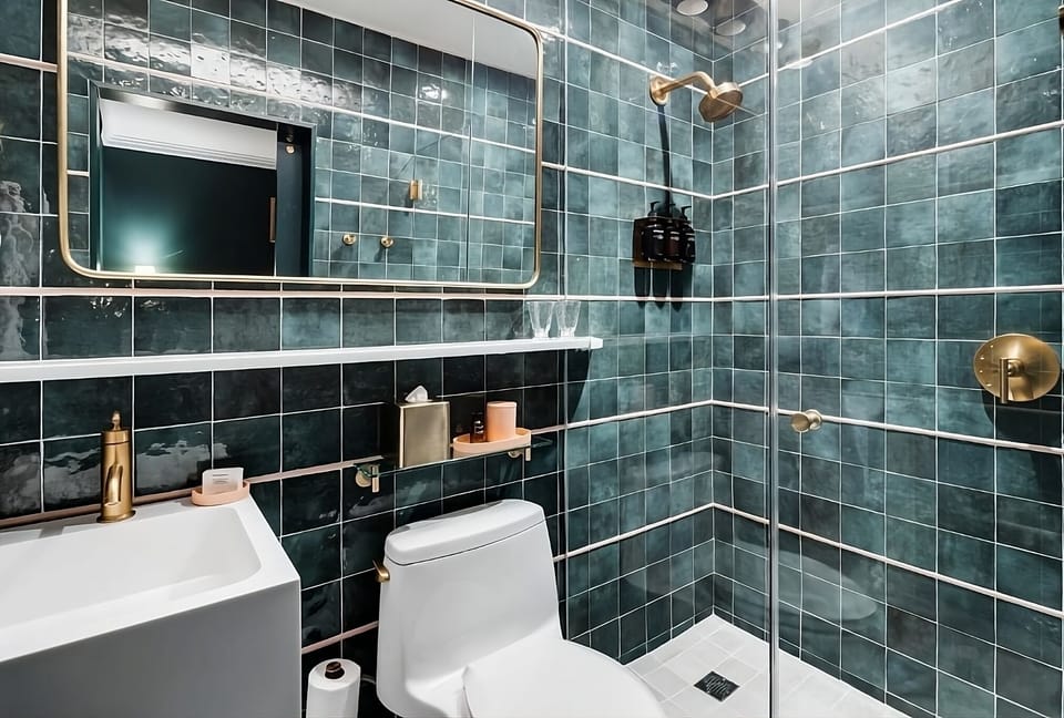 Rinse off in a sleek tiled shower with premium dispensers.