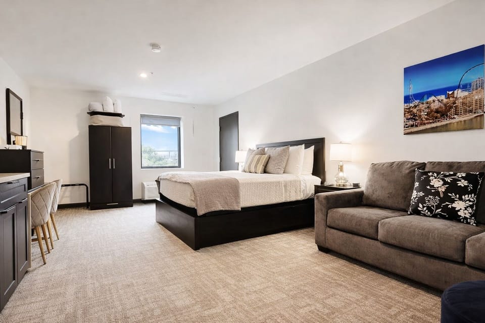 Unwind in this stylish, spacious retreat featuring a plush bed, cozy sofa, and sleek modern touches. Enjoy vibrant decor, comfy seating, and natural light—perfect for relaxing after a day at Cedar Point or exploring Sandusky!