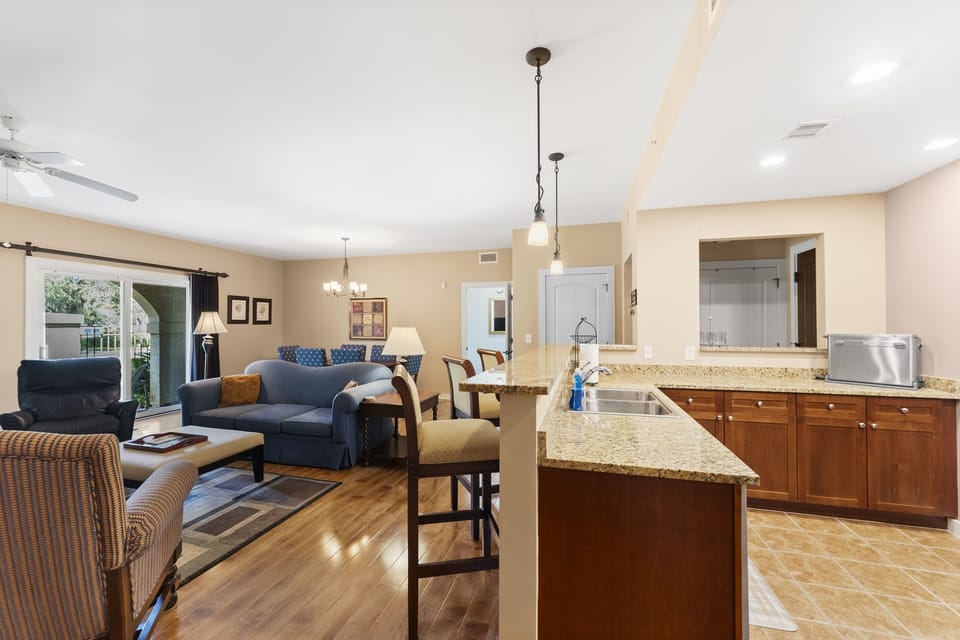 Bright, fully equipped kitchen flowing seamlessly into the inviting living room.