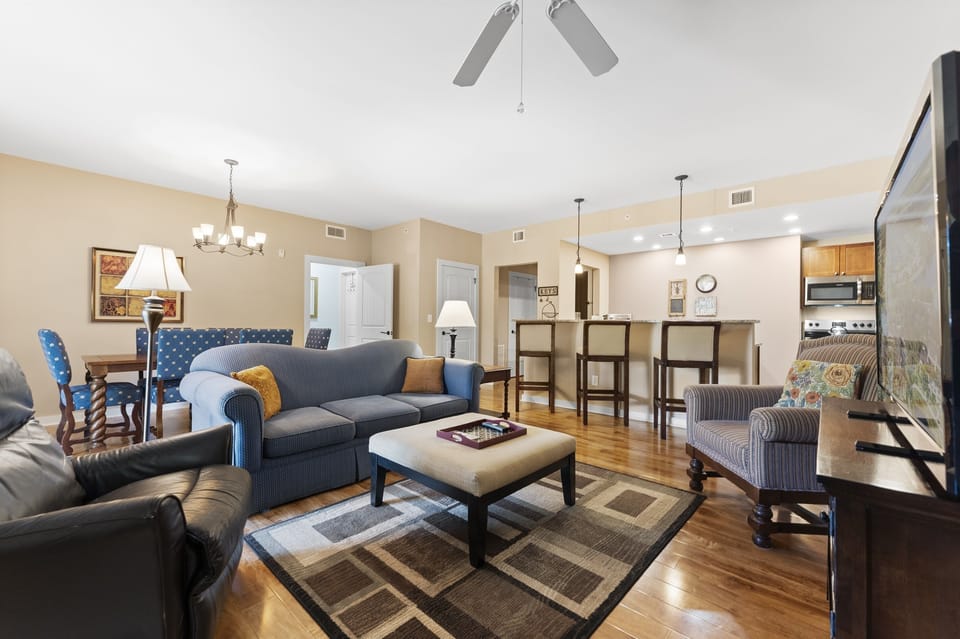Bright open-concept living and dining space with cozy seating, ideal for gathering and relaxing.