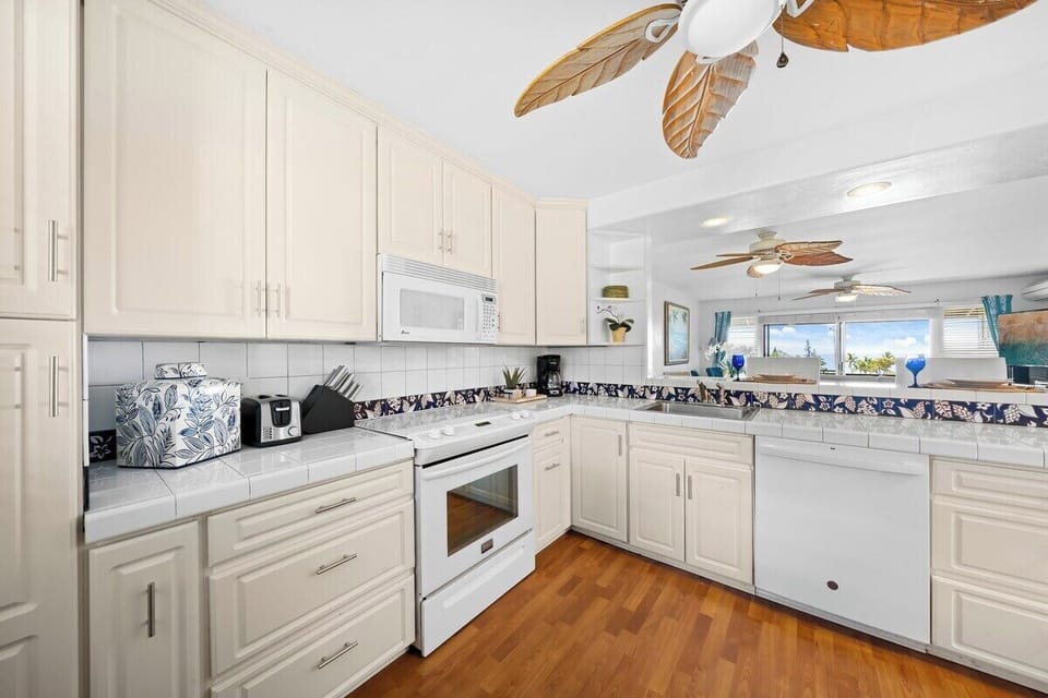 Enjoy cooking in your fully furnished kitchen with white appliances