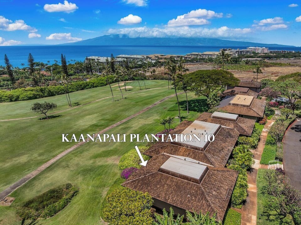 Aerial view of Kaanapali Plantation framed by lush golf course greens and shimmering ocean views