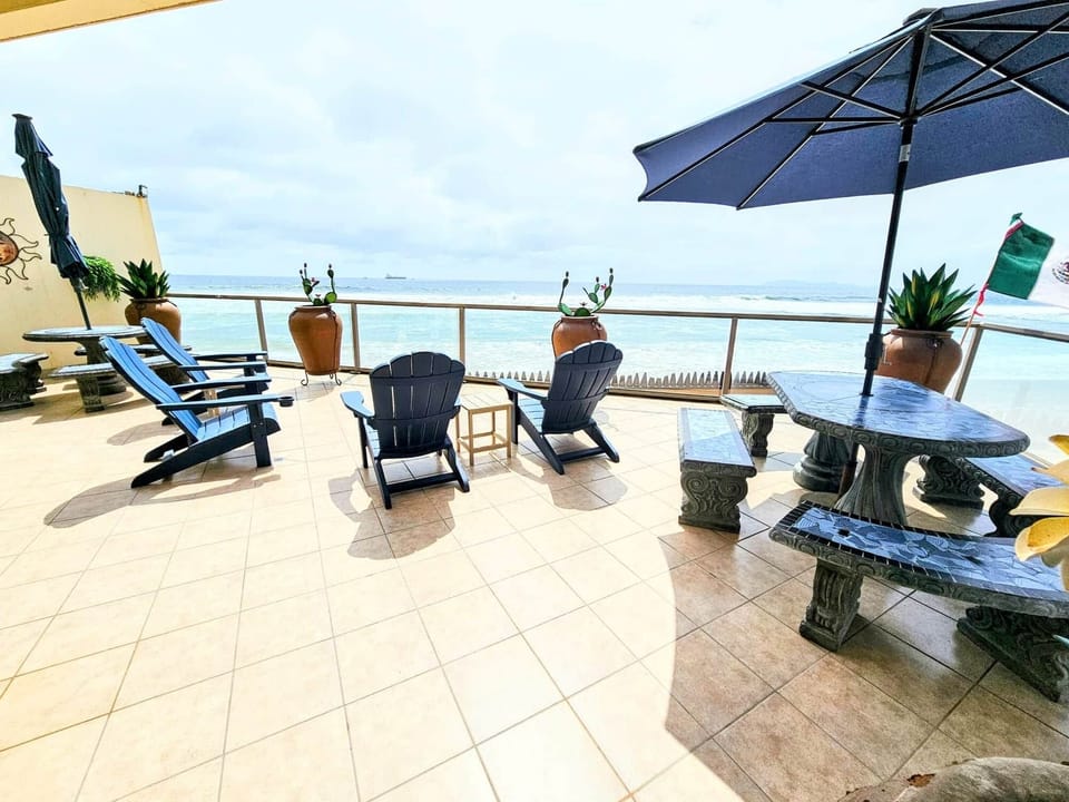 Patio with two dining tables and lounge chairs