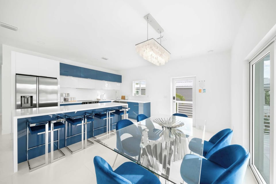 Experience culinary bliss in this bright, stylish kitchen with chic blue accents!