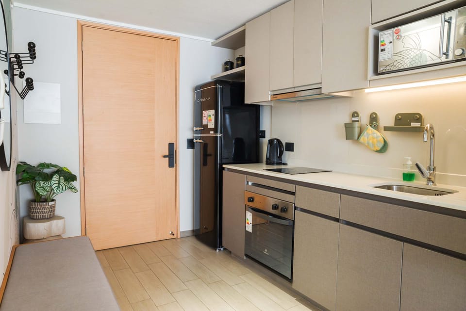 Stylish kitchenette with modern appliances, perfect for cozy meals and quick snacks.