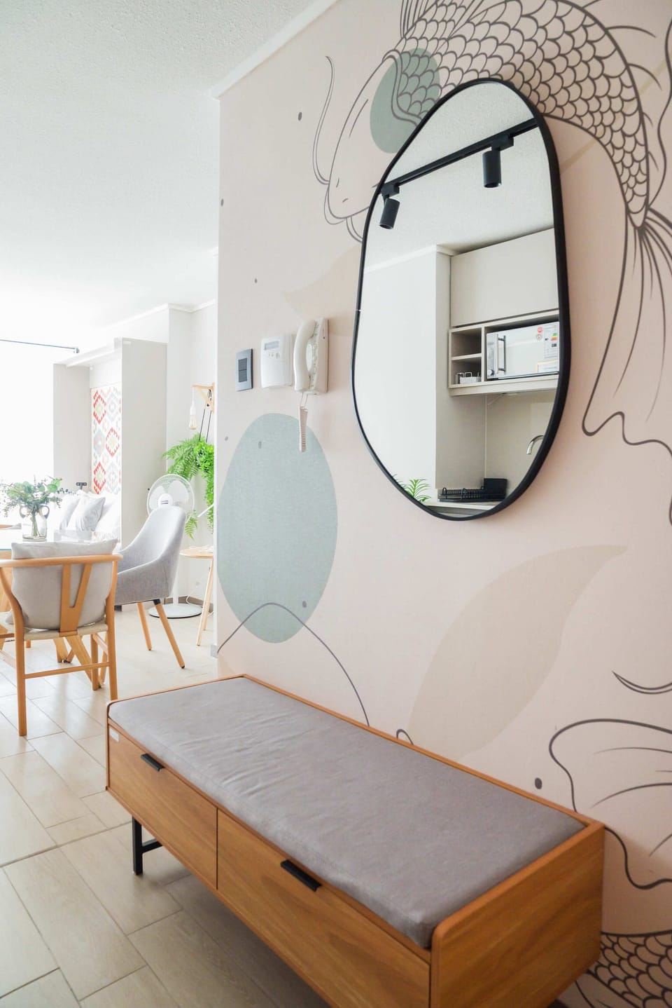 Stylish studio with modern decor, natural light, and cozy seating, perfect for relaxation and dining.