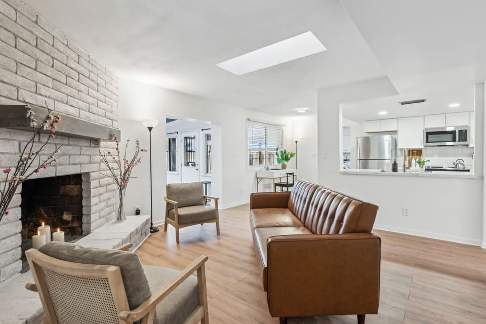 Entertain, relax, recharge by the fireplace in this central sitting room just off the kitchen.