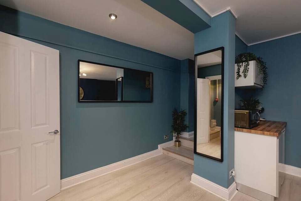 Modern compact kitchen with wood worktop and oven

