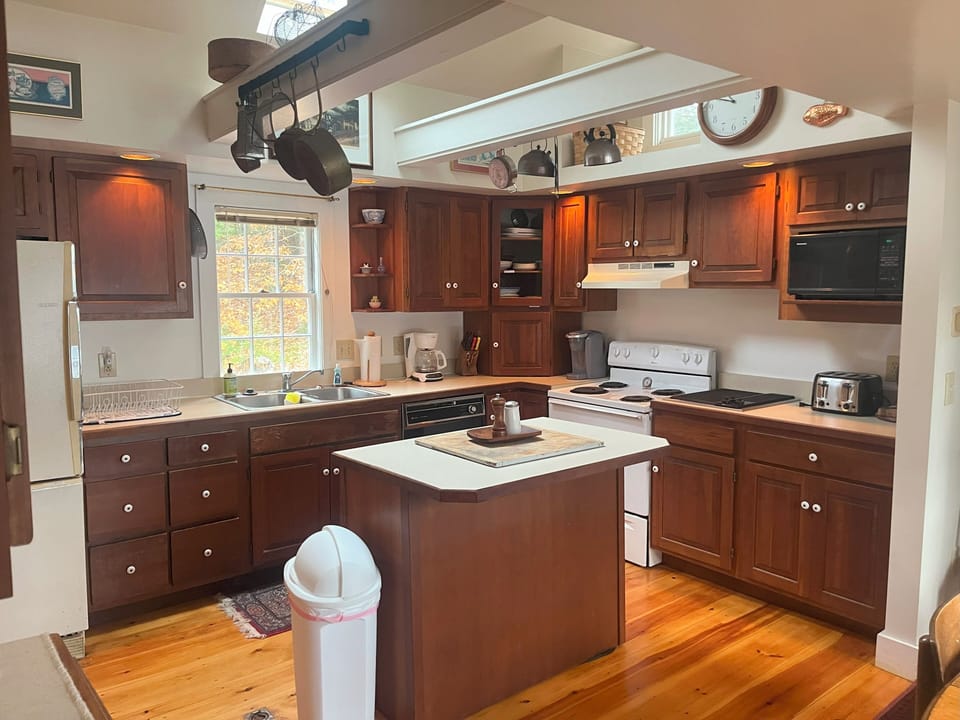 Your fully-equipped kitchen awaits with rich wood cabinets, granite counters, and center island—perfect for cooking memorable meals.