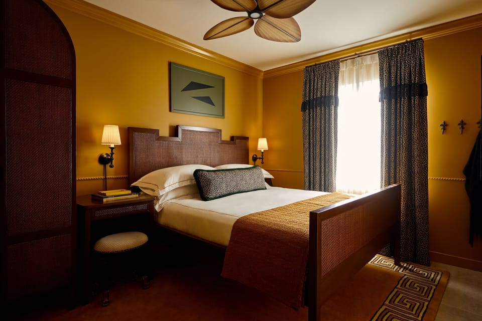 Unwind in a sunlit bedroom with rich colors and crisp linens.