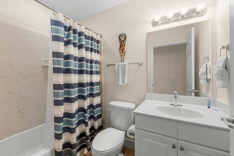 The guest bathroom features a shower‑tub combo and a vanity with plenty of space for getting ready.