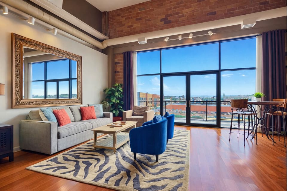 Bright & Airy Living Space
This sunlit living room blends modern comfort with warm, earthy tones. Floor-to-ceiling windows provide stunning views, while plush seating invites you to relax in style.