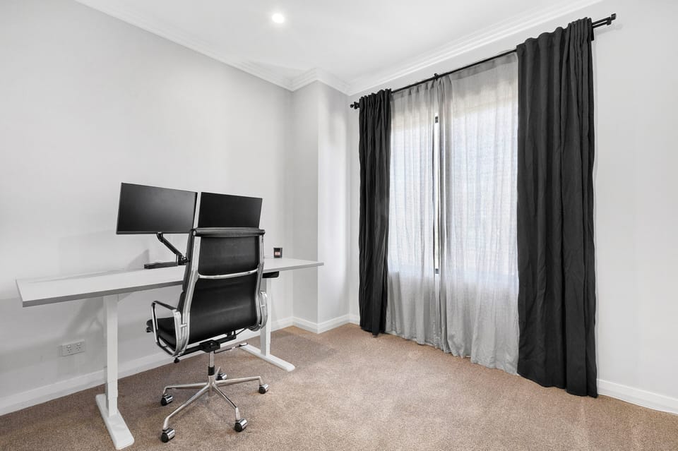 Comfortable working space with dual monitor, desk and office chair 