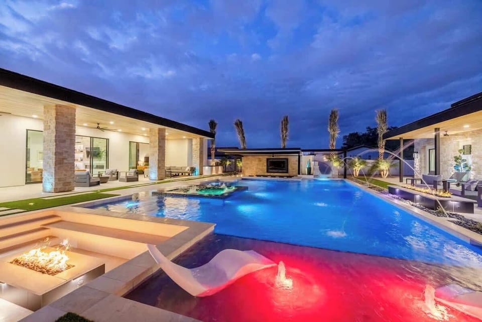 Watch the sunset from poolside loungers with fire pits and water features