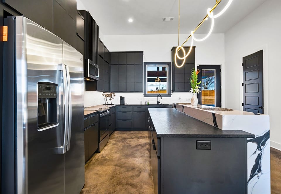 This beautifully designed kitchen offers the best of modern style and functionality, with expansive counter space and a layout that flows effortlessly into the home.