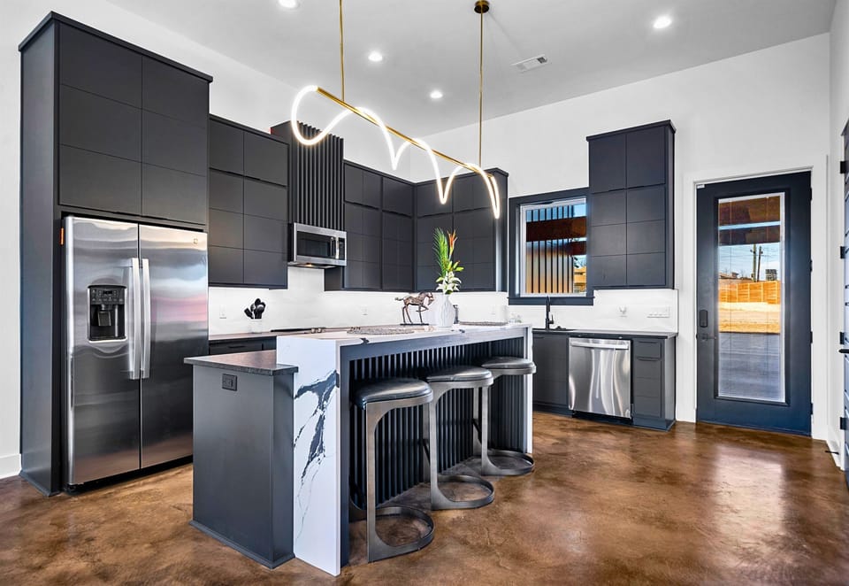 A seamless blend of elegance and functionality, this open-concept kitchen and dining area features sleek finishes, a spacious island, and thoughtful design touches.