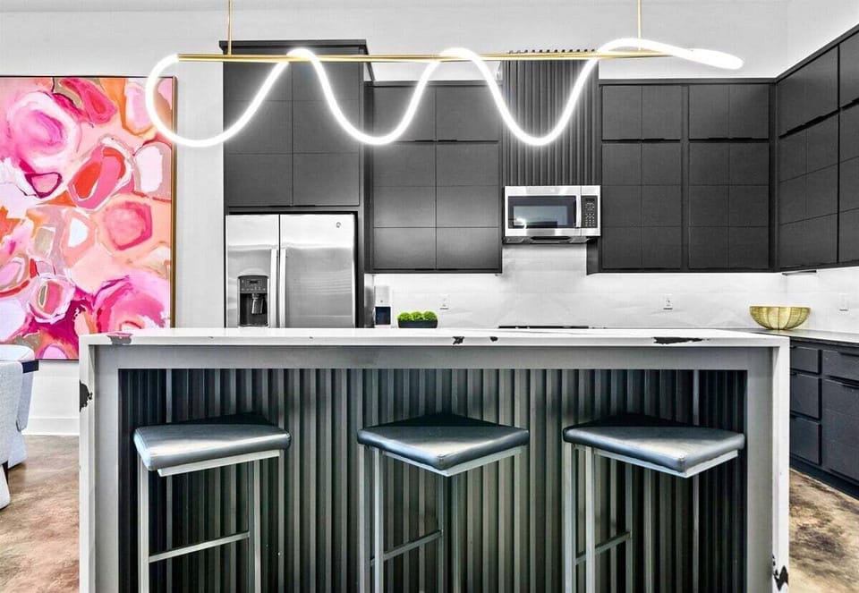 A chef's dream kitchen with high-end appliances, clean lines, and a welcoming island that effortlessly blends form and function.