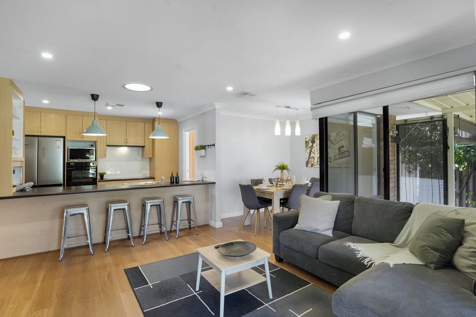 Spacious open-concept living room with fully equipped kitchen