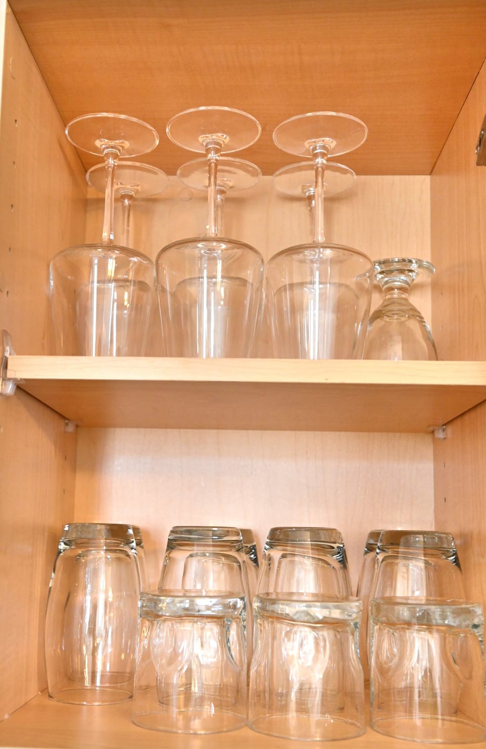 Cabinets with glassware ready for family meals and drinks