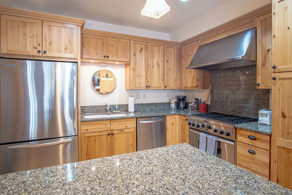Fully equipped kitchen with modern appliances and bistro dining table for 4