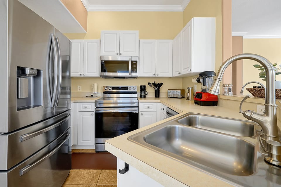 Fully equipped kitchen with stainless steel appliances and ample counter space for family cooking.