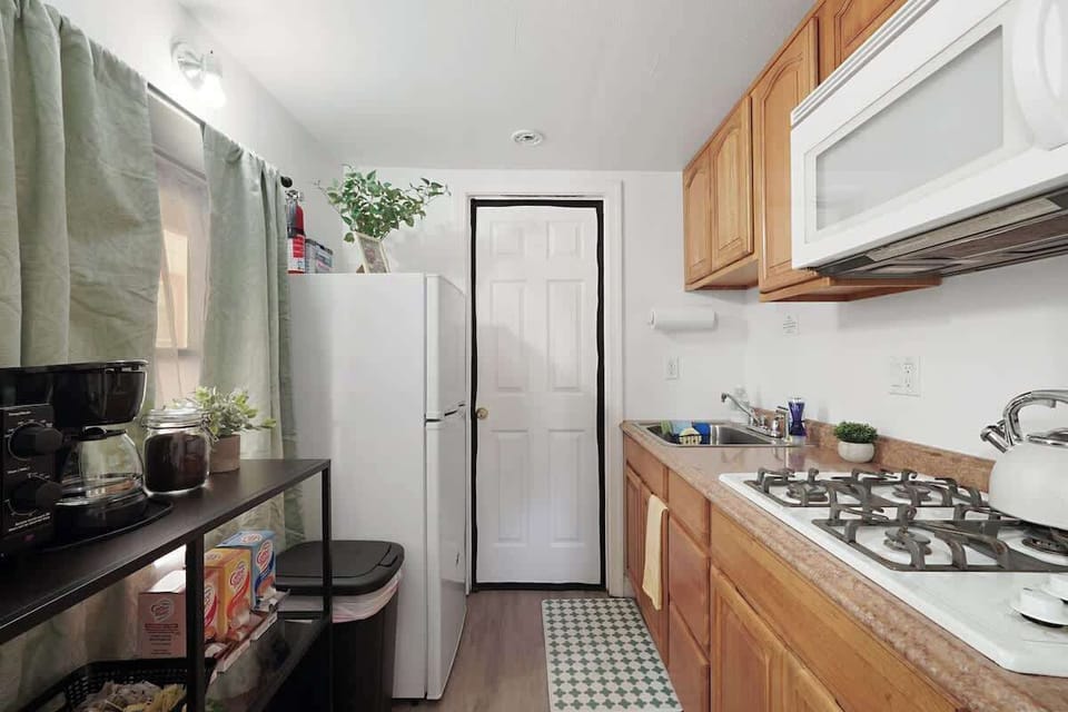 Compact kitchen with essential appliances and a simple setup for easy meal prep.
