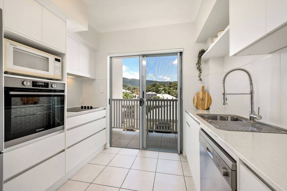 A spacious kitchen equipped with modern appliances and plenty of counter space makes meal preparation a breeze.