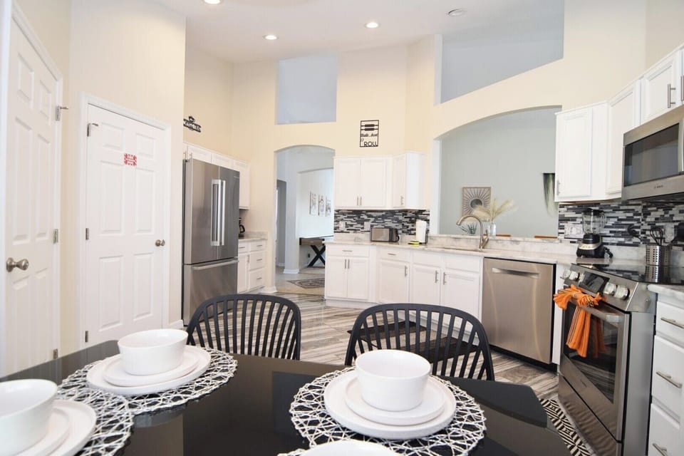 Huge kitchen with stone counters, stainless steel appliance, breakfast nook