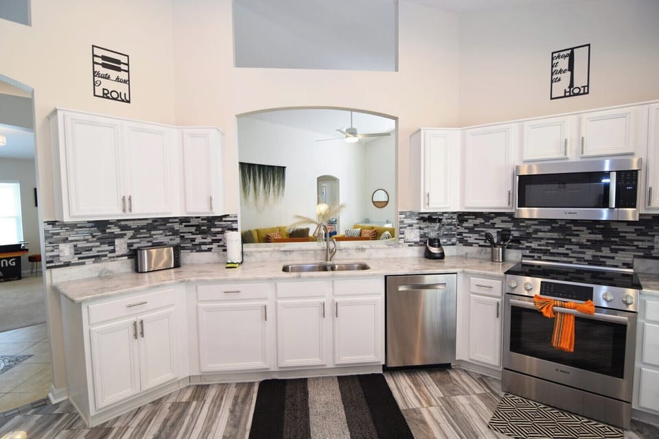 Huge kitchen with stone counters, stainless steel appliance, breakfast nook
