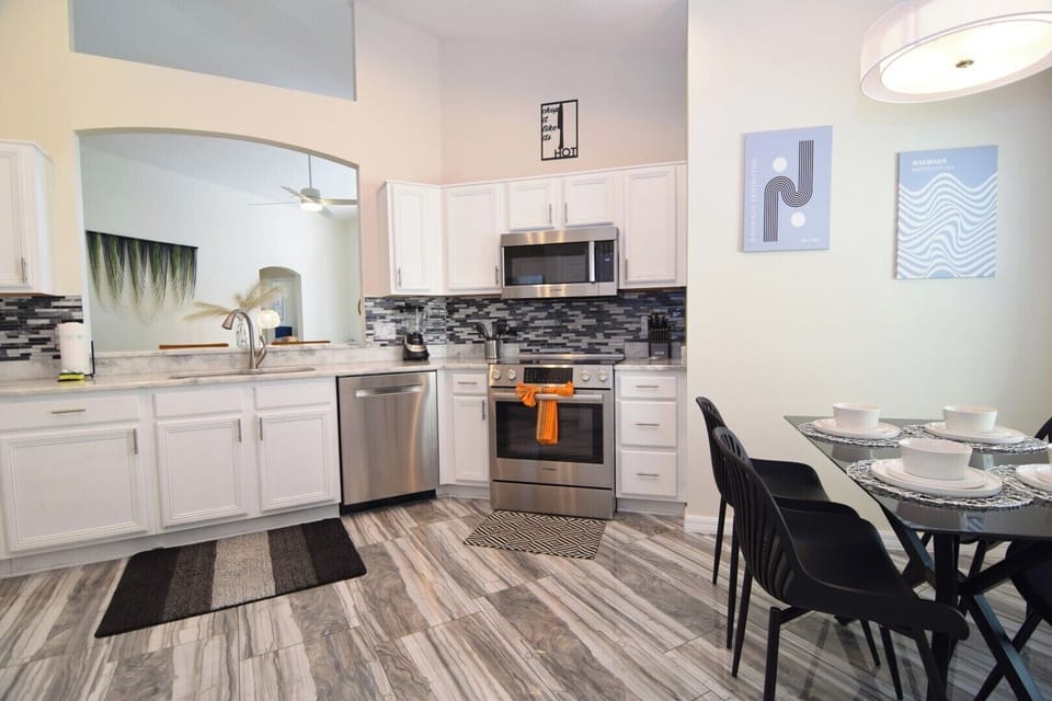 Huge kitchen with stone counters, stainless steel appliance, breakfast nook