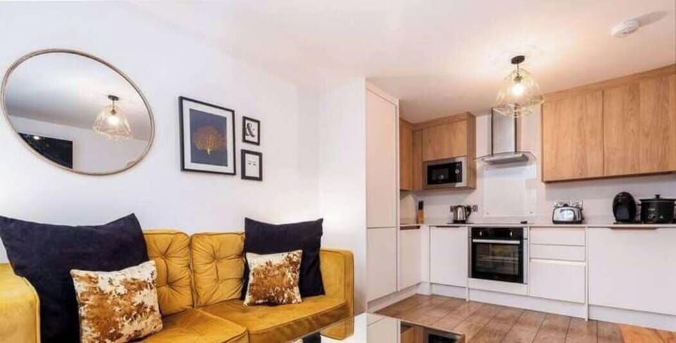A stylish and comfortable living room, filled with natural light and cozy seating for relaxing or socializing