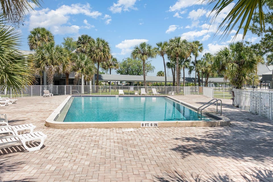 Dive into the expansive pool area, surrounded by tropical landscaping and plenty of seating for a perfect day in the sun.
