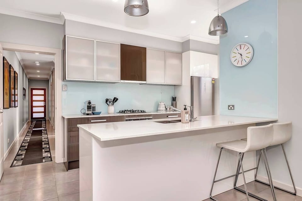 Challenge your inner chef in this fully-equipped kitchen, designed for those who love cooking at home. With a kitchen island bench, modern design, and essentials like a Nespresso machine, every meal prep is a breeze.