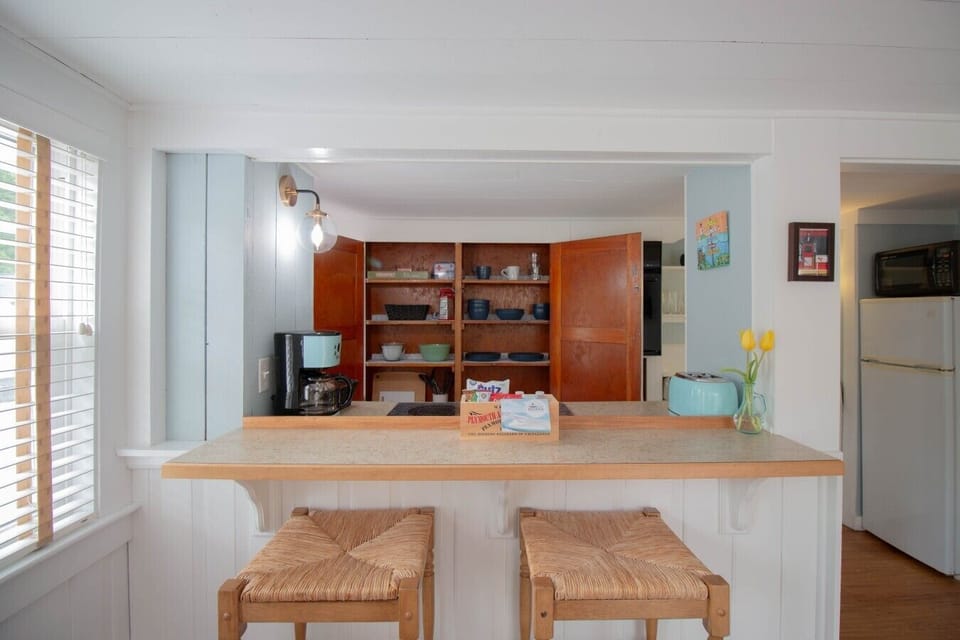 This fully stocked kitchen is equipped with everything you need, including plates, bowls, silverware, mixing bowls, wine glasses, mugs, pots and pans, cooking utensils, cutting boards, and more!