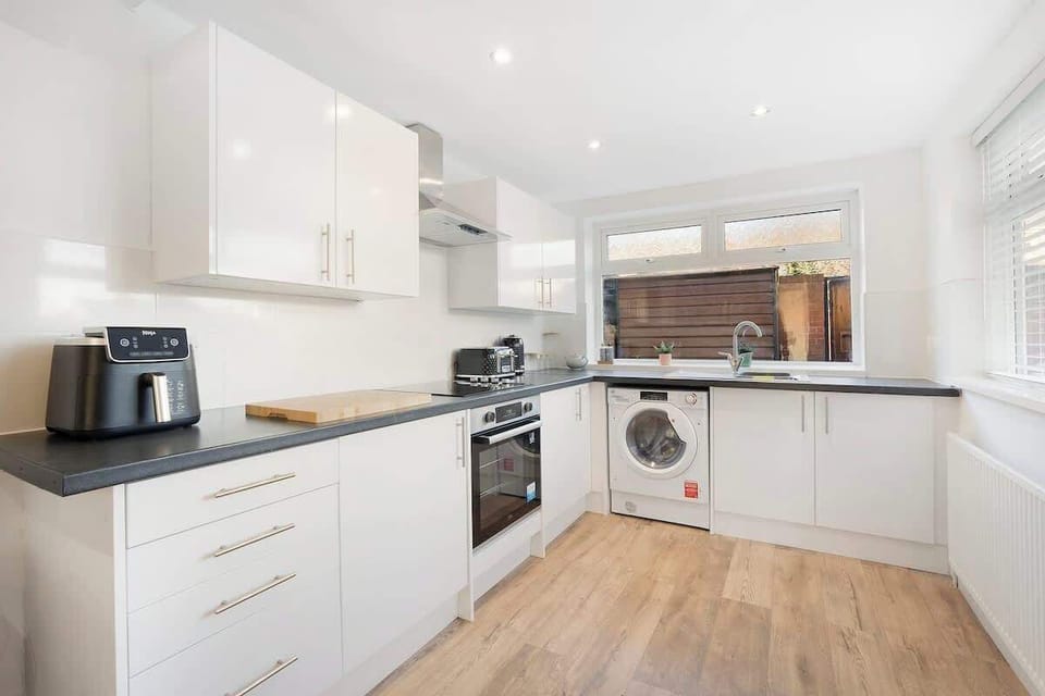 Kitchen equipped with all essentials, including a washer & dryer, oven, fridge and full cookware set.