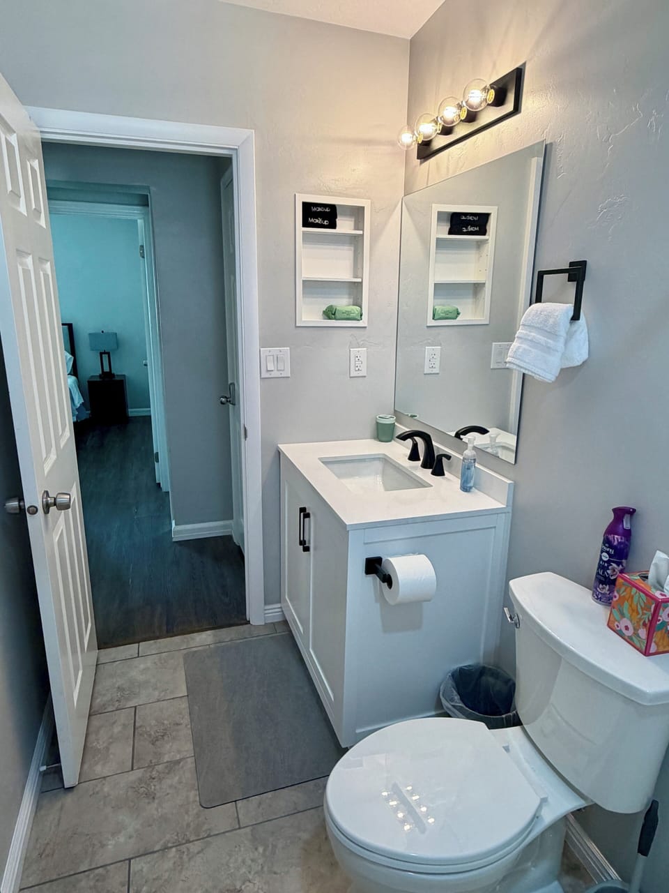 Bright modern bathroom with sleek vanity, black fixtures, and clean finishes