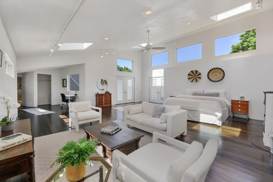 Open and airy master bedroom with king bed and air conditioning.