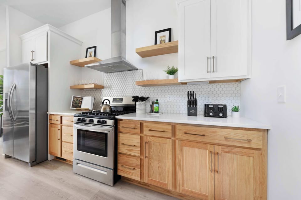 Clean and Spacious Kitchen with Sleek Countertops and Additional Seating