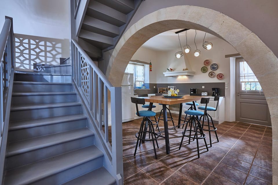 The kitchen also features a high-top table with six stools for casual dining